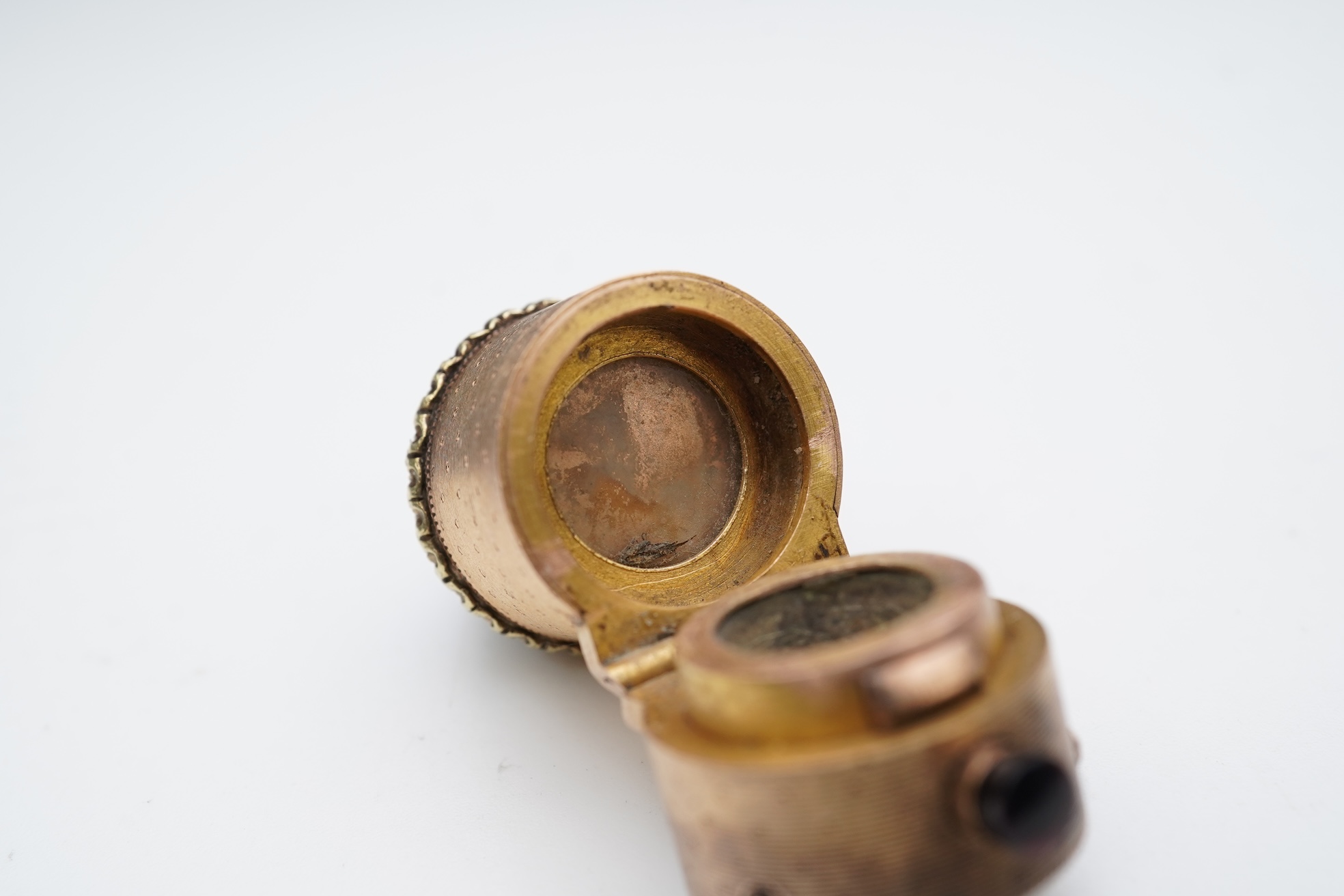 A gold and garnet perfume bottle top, France, late 19th century